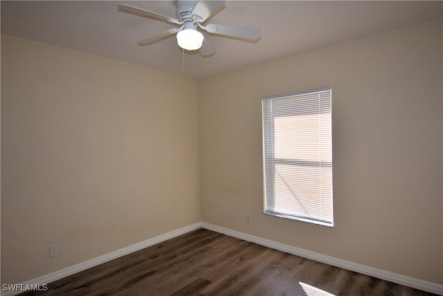 empty room featuring ceiling fan and dark hardwood / wood-style floors