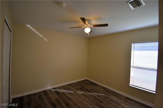 unfurnished room with dark wood-type flooring