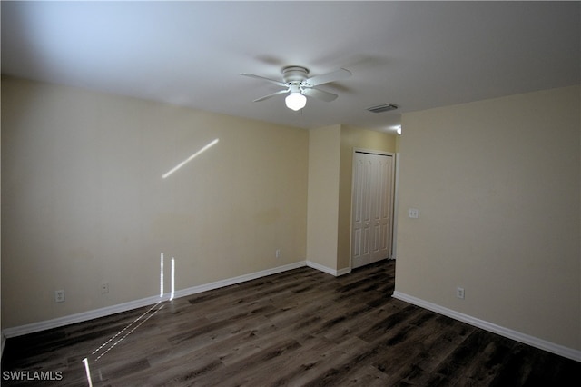 spare room with dark hardwood / wood-style floors and ceiling fan