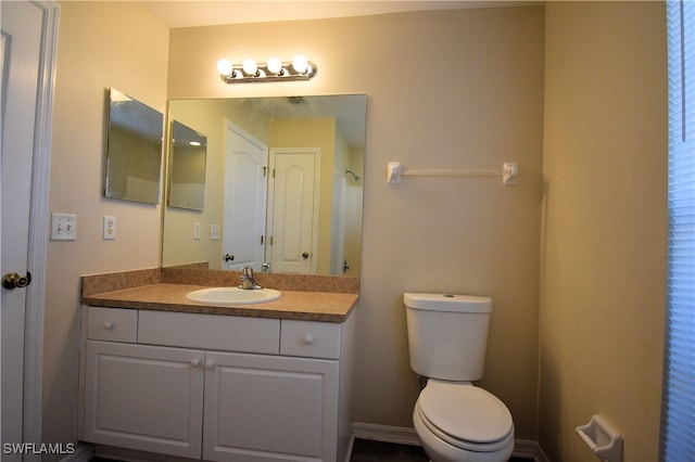 bathroom featuring vanity and toilet