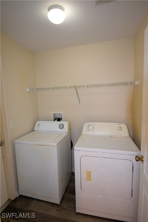 laundry room with dark hardwood / wood-style floors and separate washer and dryer