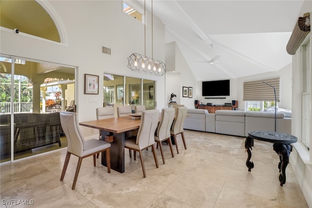 dining space featuring beamed ceiling, ceiling fan with notable chandelier, and high vaulted ceiling