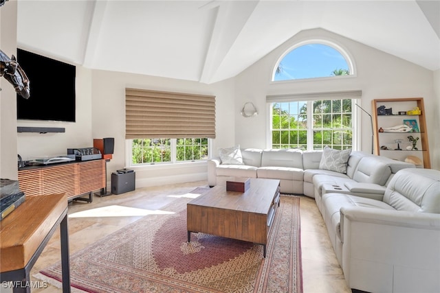 living room featuring a wealth of natural light, light tile patterned flooring, and high vaulted ceiling