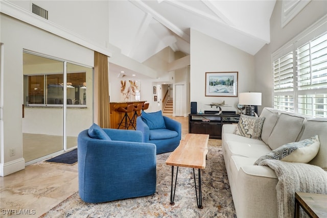 living room featuring high vaulted ceiling