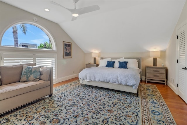 bedroom with wood-type flooring, ceiling fan, and lofted ceiling