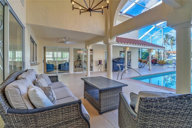 view of swimming pool with a lanai, ceiling fan, a patio area, and an outdoor hangout area