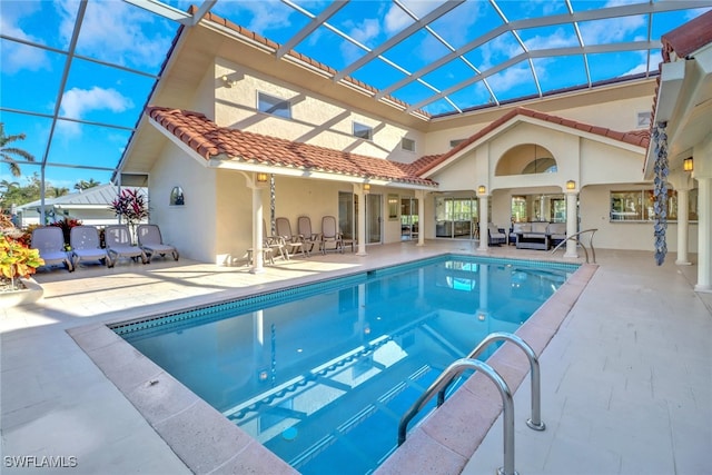 view of pool featuring an outdoor living space, a patio, and a lanai