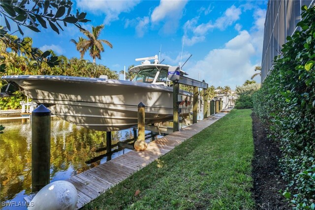 view of home's exterior featuring a lawn, a water view, and a dock