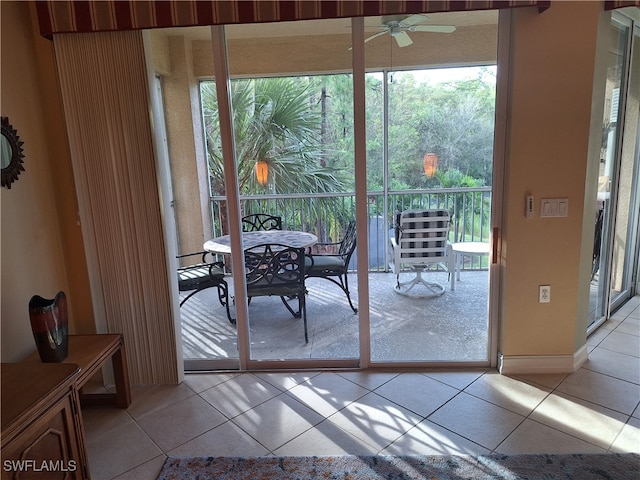 doorway to outside featuring ceiling fan, plenty of natural light, and light tile patterned flooring