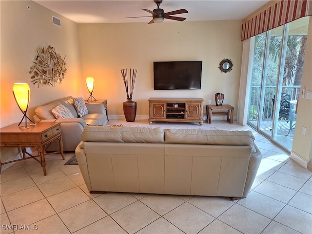 living room featuring light tile patterned floors and ceiling fan