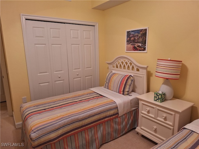 carpeted bedroom with a closet