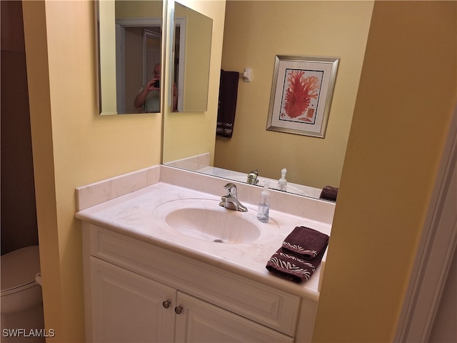 bathroom featuring vanity and toilet