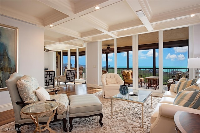 sunroom with beamed ceiling, ceiling fan, and coffered ceiling