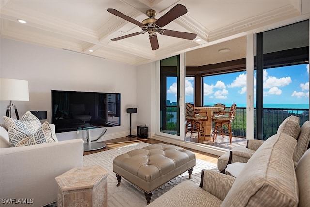 living room with ceiling fan, crown molding, coffered ceiling, and light wood-type flooring