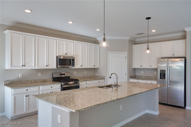 kitchen with white cabinets, sink, stainless steel appliances, and a kitchen island with sink