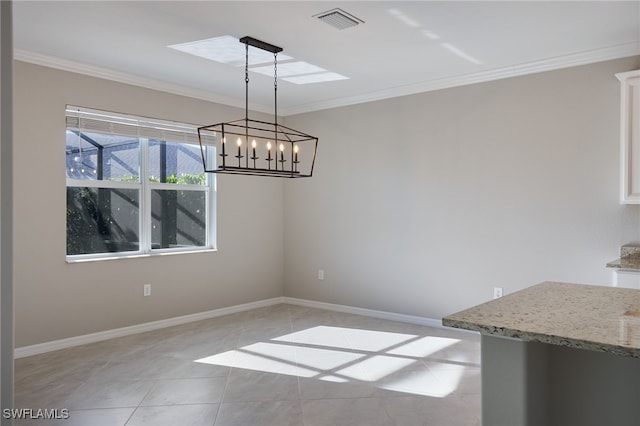 unfurnished dining area with light tile patterned flooring, ornamental molding, and a notable chandelier