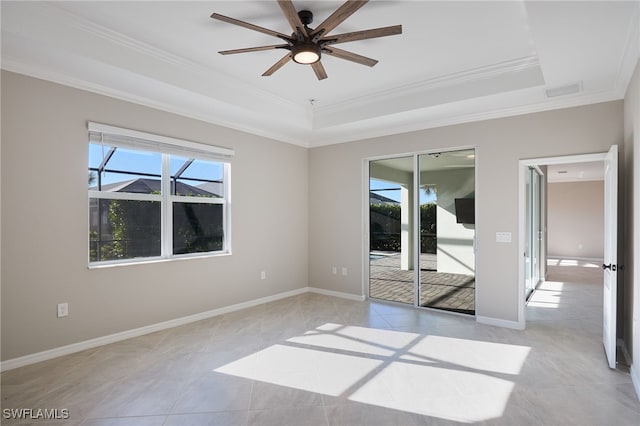 spare room featuring a raised ceiling, ceiling fan, crown molding, and light tile patterned floors