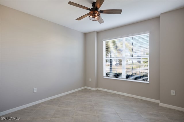 tiled empty room with ceiling fan