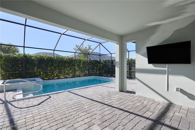 view of swimming pool with a patio area and a lanai