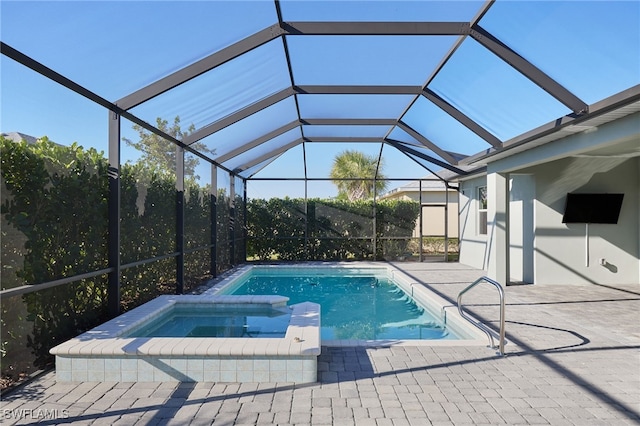 view of swimming pool with a lanai, a patio area, and an in ground hot tub