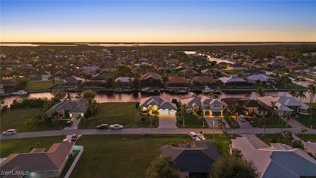 aerial view at dusk with a water view