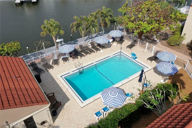 view of pool with a patio area and a water view