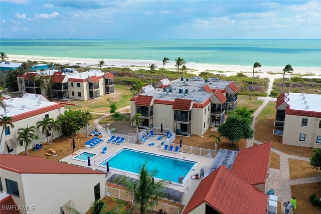 drone / aerial view featuring a view of the beach and a water view