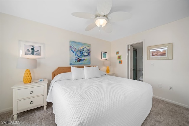 bedroom featuring light colored carpet, ceiling fan, and ensuite bathroom