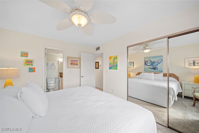 bedroom with ceiling fan, a closet, ensuite bathroom, and light carpet