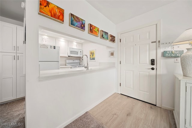 interior space featuring sink and light wood-type flooring