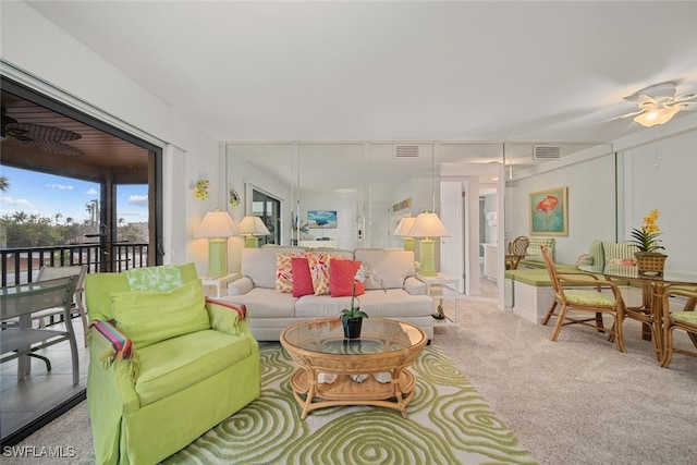 carpeted living room with ceiling fan