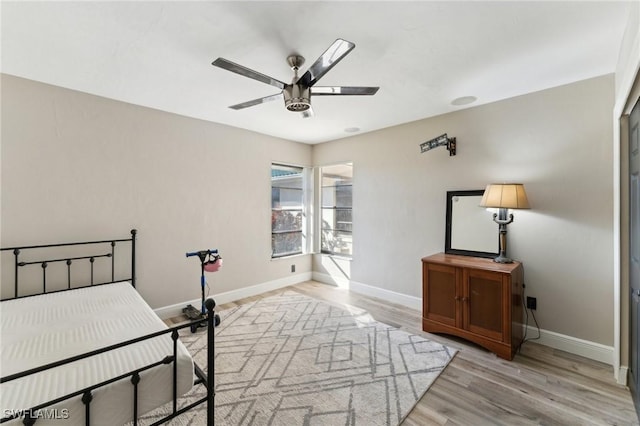 bedroom with ceiling fan and light hardwood / wood-style flooring