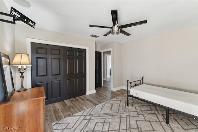 bedroom with a closet, ceiling fan, and hardwood / wood-style flooring