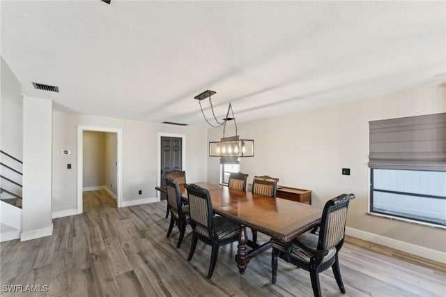 dining room with a chandelier and light wood-type flooring