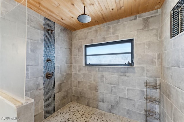 bathroom featuring wood ceiling and a tile shower