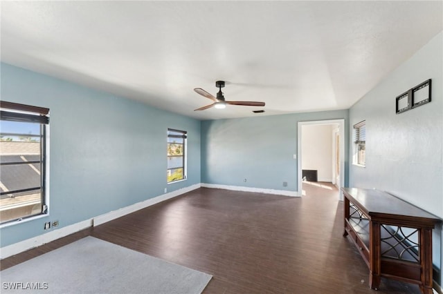 empty room featuring ceiling fan and dark hardwood / wood-style floors