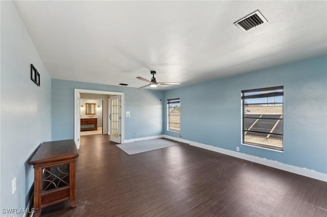 interior space featuring french doors, ceiling fan, and dark wood-type flooring