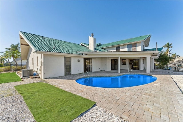 view of pool with a patio area and cooling unit