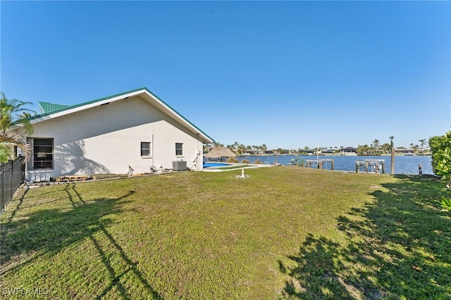 view of yard featuring central AC unit and a water view