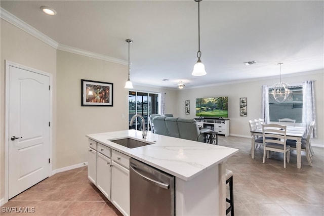 kitchen featuring dishwasher, white cabinets, sink, light stone countertops, and an island with sink