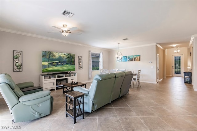 living room with ceiling fan with notable chandelier, light tile patterned flooring, and crown molding