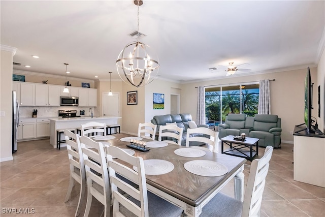 tiled dining area with ceiling fan with notable chandelier and ornamental molding