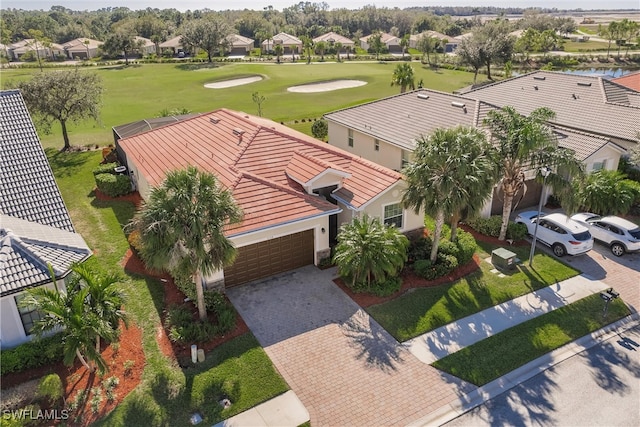 drone / aerial view with view of golf course and a residential view