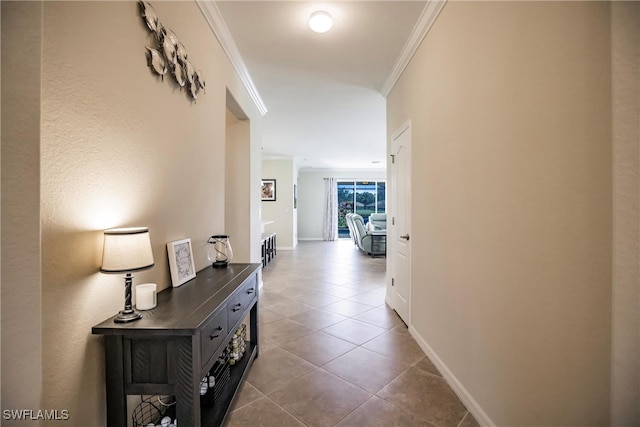 hallway featuring tile patterned flooring and ornamental molding