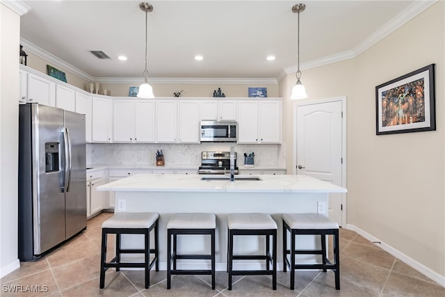 kitchen featuring appliances with stainless steel finishes, tasteful backsplash, sink, a center island with sink, and white cabinets