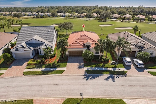 birds eye view of property featuring view of golf course and a residential view