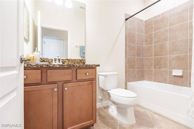 full bathroom featuring tile patterned flooring, vanity, toilet, and tiled shower / bath