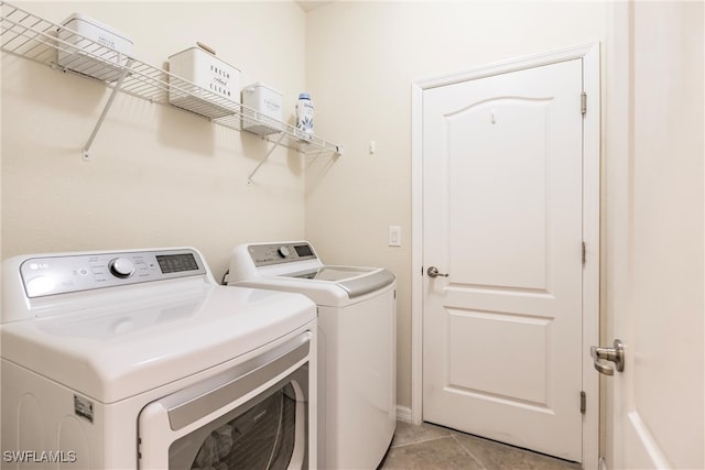 laundry room with light tile patterned flooring and independent washer and dryer