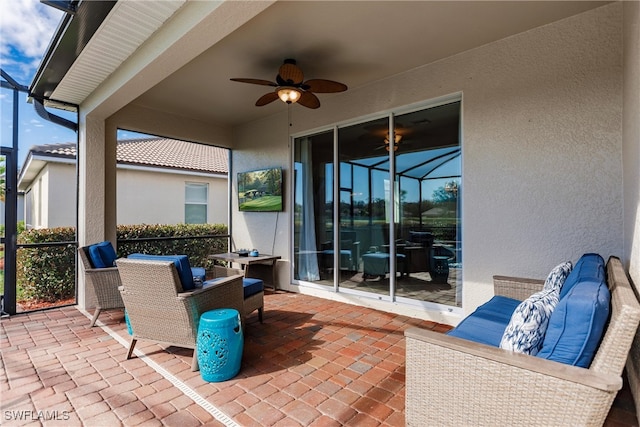 view of patio featuring glass enclosure and ceiling fan