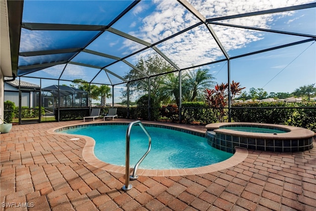 view of pool with an in ground hot tub, a patio, and glass enclosure